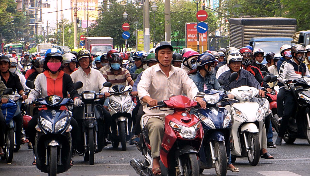 Saigon traffic. Interestingly, Mark notice that everyone wears helmets. Or almost everyone; kids don't. Strange world where every adult wears a helmet but the kids don't.