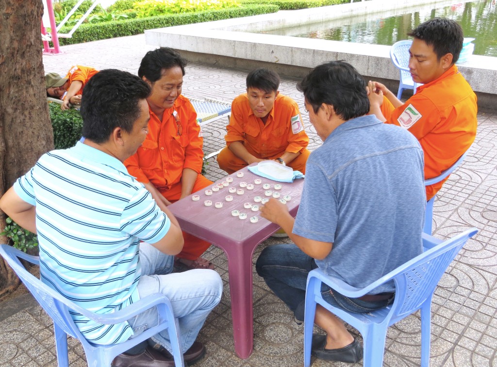 These guys, including the guys in orange who I'm pretty sure are municipal workers, were playing this game when I walked past on my way to the market and still at it a couple hours later when I came back heading home. Sure glad that never happens with municipal workers in the U.S.! (Notice the guy napping behind them…)