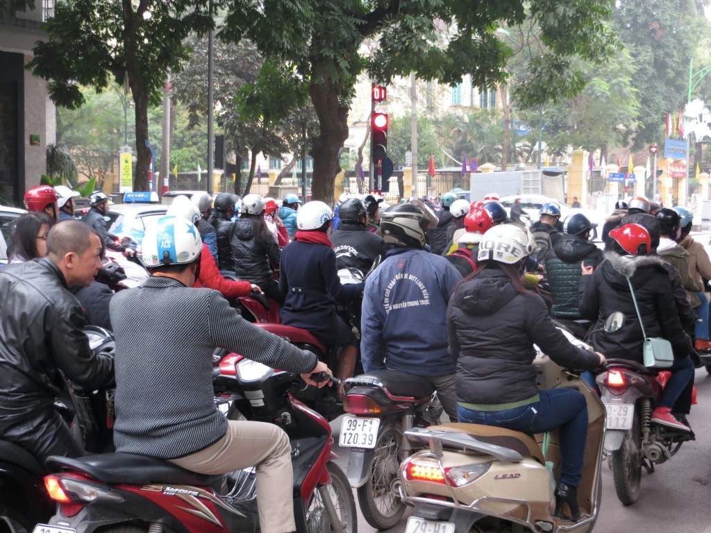 The traffic in Hanoi is a seething life form of its own unique nature. Traffic lights are suggestions. Crosswalks have no meaning whatsoever. Honking your horn means "I'm coming through no matter who or what is in the way." And since sidewalks are given over to scooter parking and shops and tiny restaurants, pedestrians share the street with all these scooters and cars.