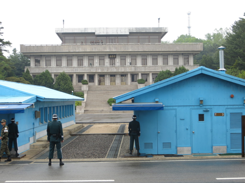 The Joint Security Area at the border between North & South Korea. These are South Korean soldiers, with the sentry standing half exposed and half hidden, to minimize the amount of target he exposes to the North. The building in the background is in North Korea, with high-ranking military officials on the upper balcony watching us (or, more likely, watching the military people all around us).