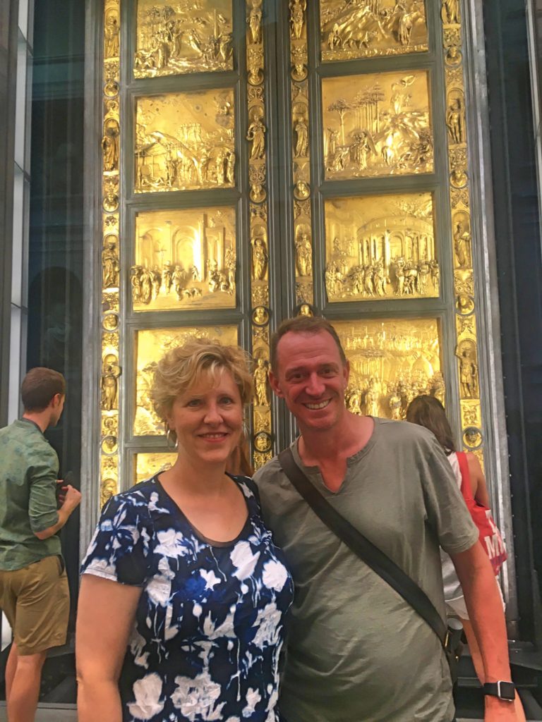 Laura & Mark in front of the original doors to the Baptistry of St. John, now kept in the Grand Museum. Created by Lorenzo Ghiberti in the early 15th century, Michelangelo called them the Gates of Paradise.