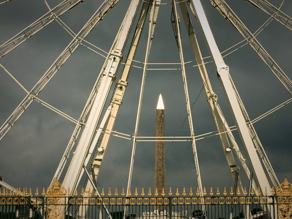 And a very artsy picture of the ancient Egyptian obelisk in the Place de la Concorde, seen through the spokes of a giant Ferris Wheel