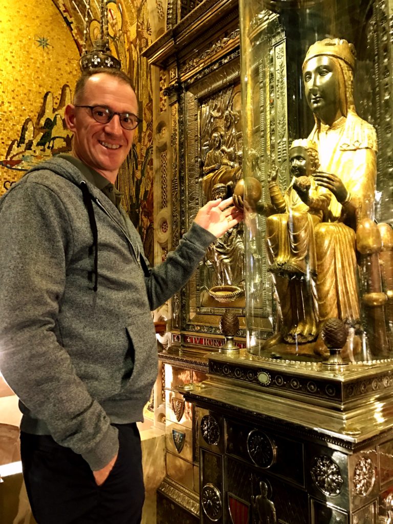 Mark with the venerated Black Madonna. She's behind glass but there's a cutout so you can touch her hand. I think he's blessed now, or something like that.